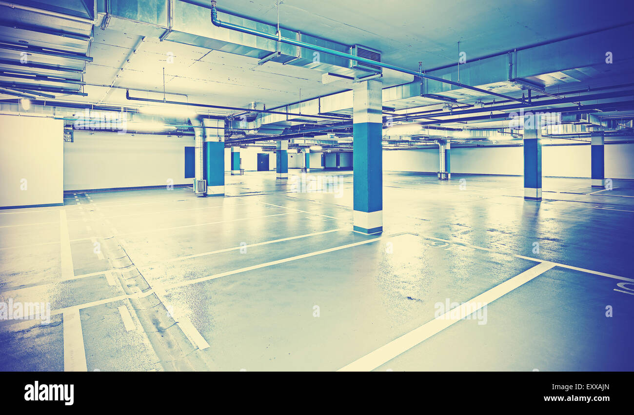 Instagram toned photo of underground parking, industrial background. Stock Photo