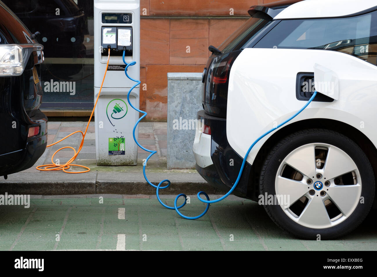 Two electric cars charging on a city street, UK Stock Photo