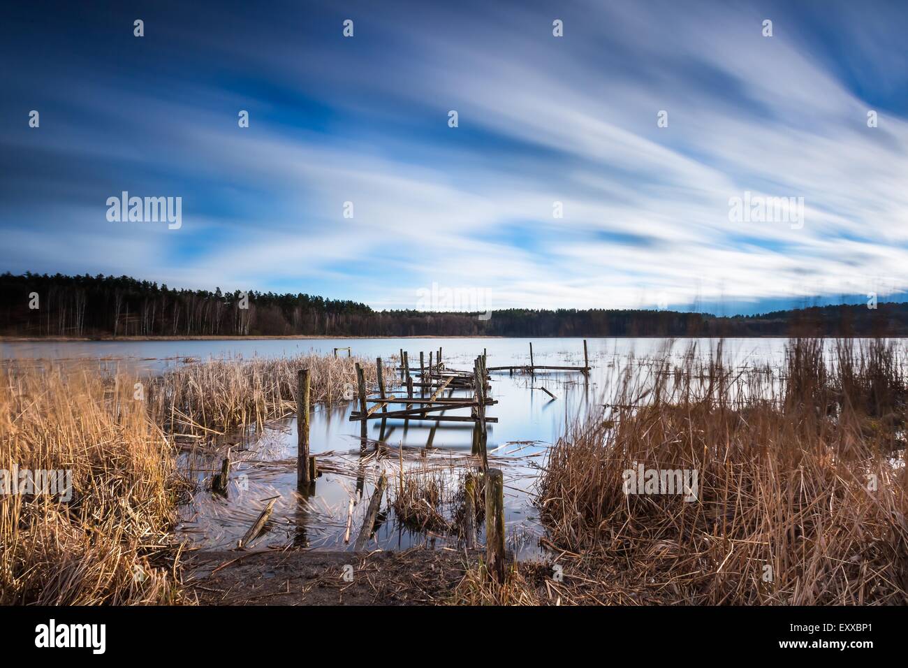 Small pier on lake, beautiful long exposure photo. Mazury lake district. Stock Photo
