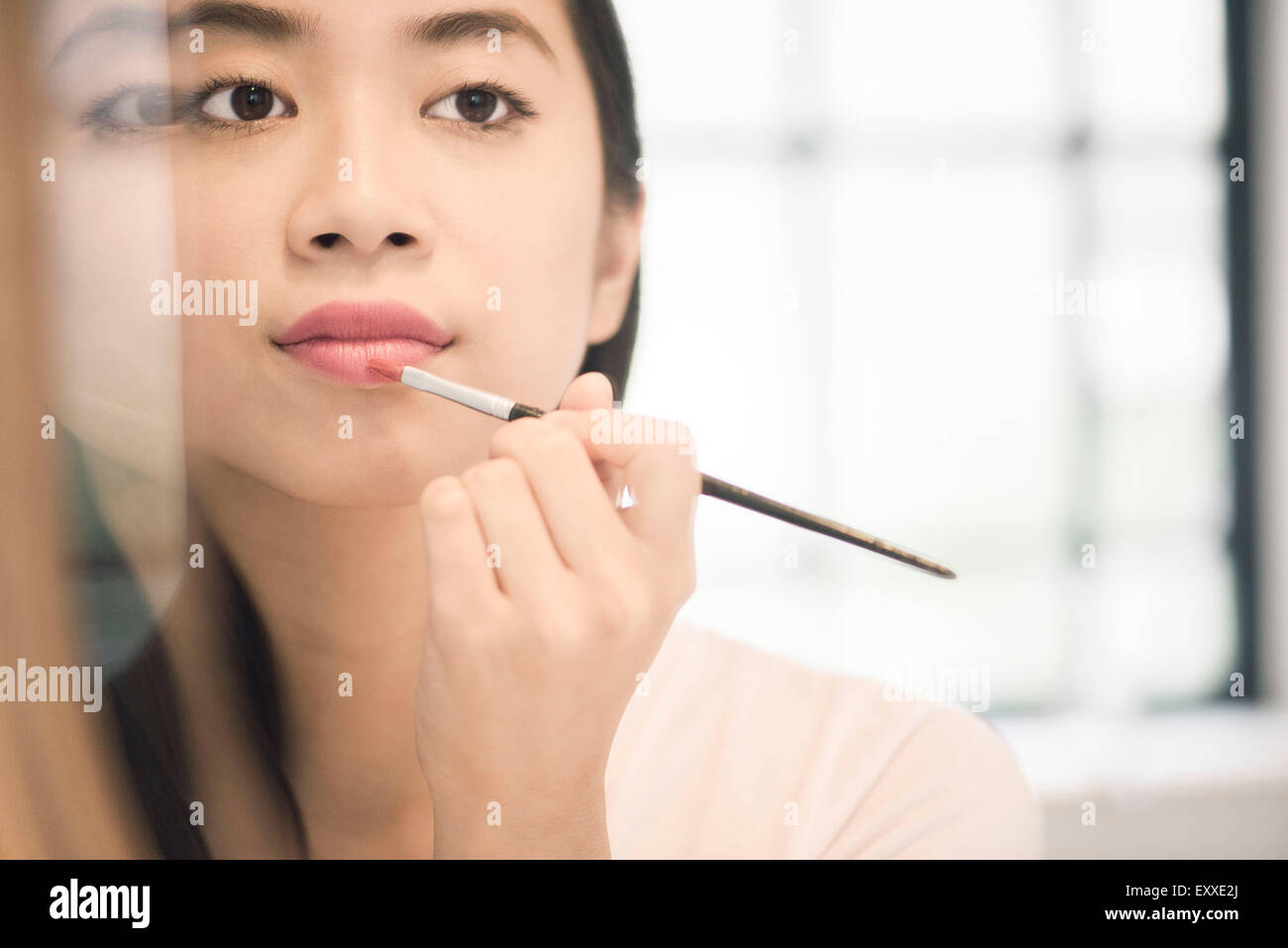 Woman applying lipstick Stock Photo