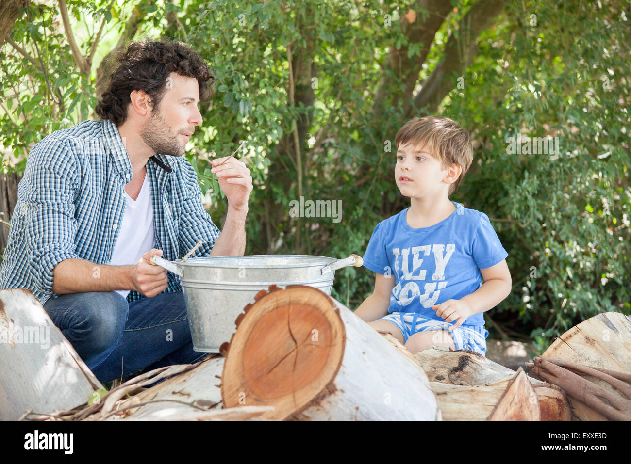 Father with young son chatting together outdoors Stock Photo