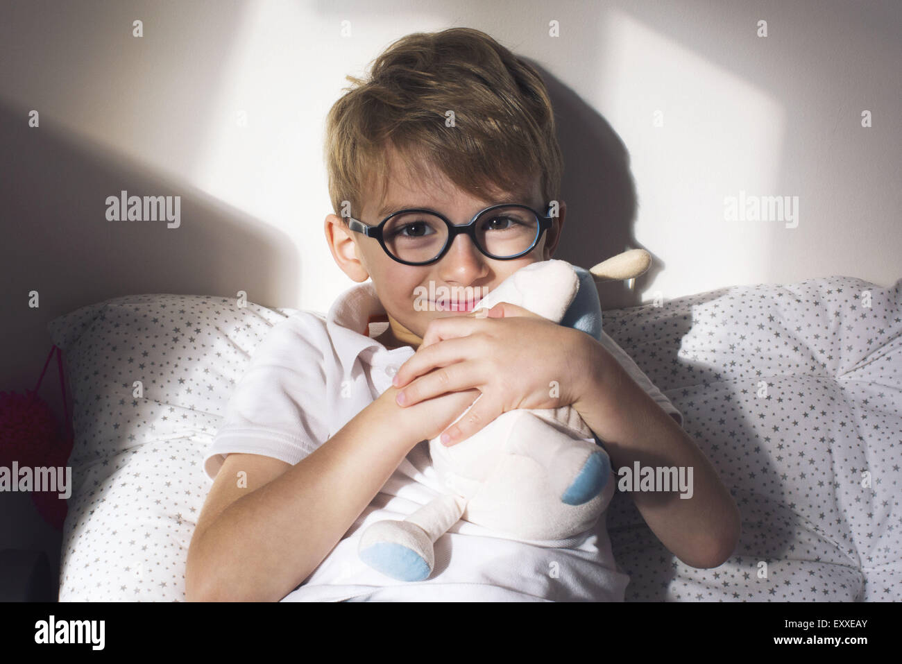 Little boy hugging stuffed toy Stock Photo