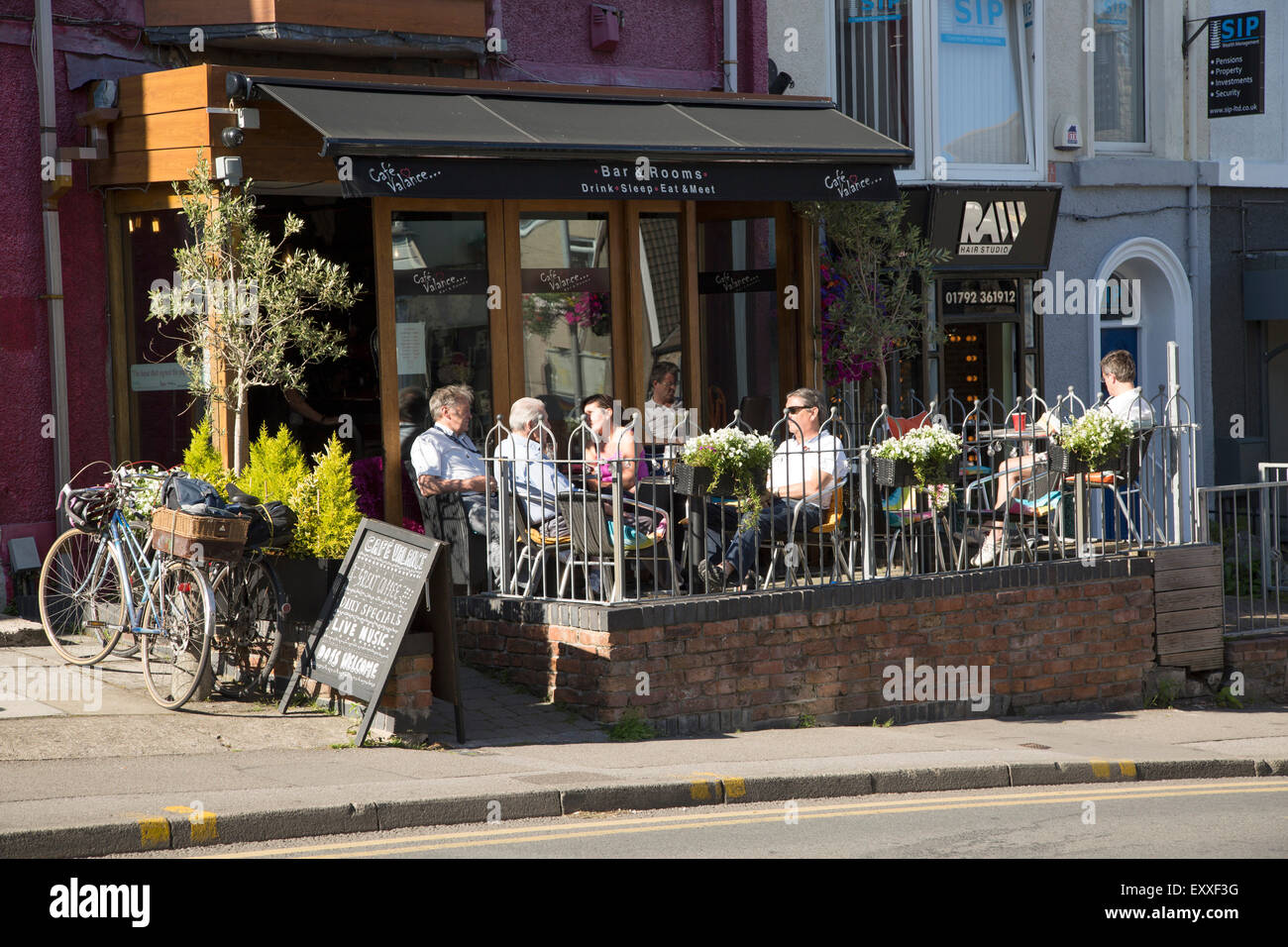 People sitting outside cafe bar, Oystermouth, Mumbles, Gower peninsula, near Swansea, South Wales, UK Stock Photo