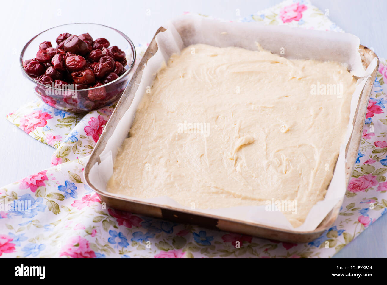 Raw dough and cherry for cake before the baking, selective focus Stock Photo