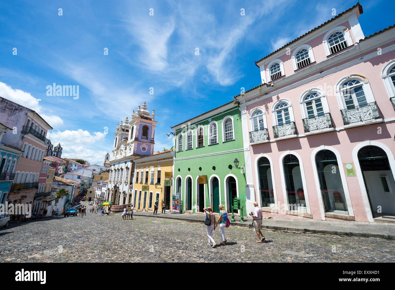 SALVADOR, BRAZIL - MARCH 12, 2015: Pedestrians walk through a plaza surrounded by colonial buildings in the Pelourinho district. Stock Photo