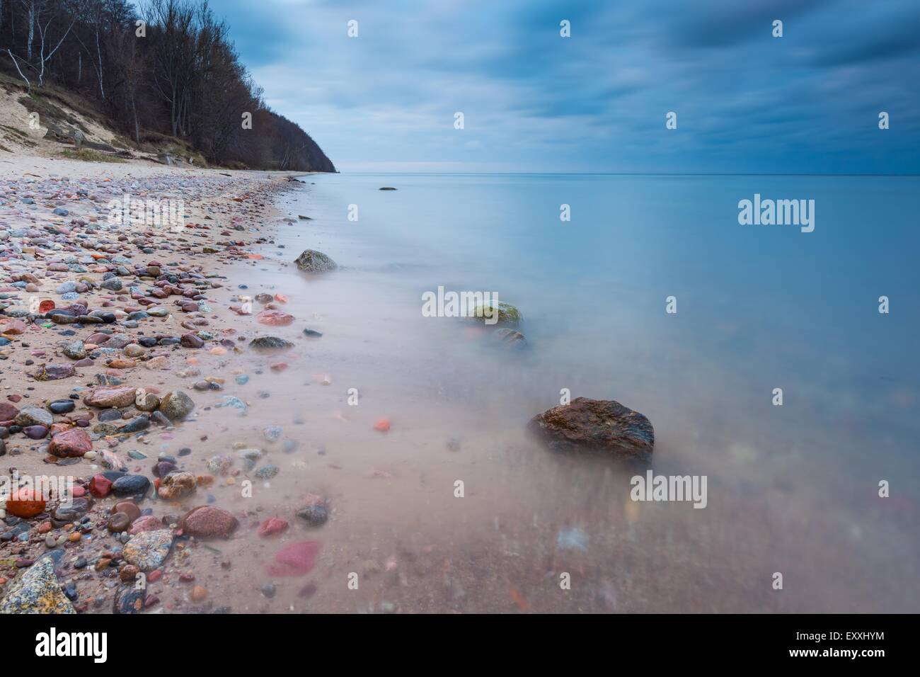 Beautiful rocky sea shore at sunrise or sunset. Long exposure landscape ...