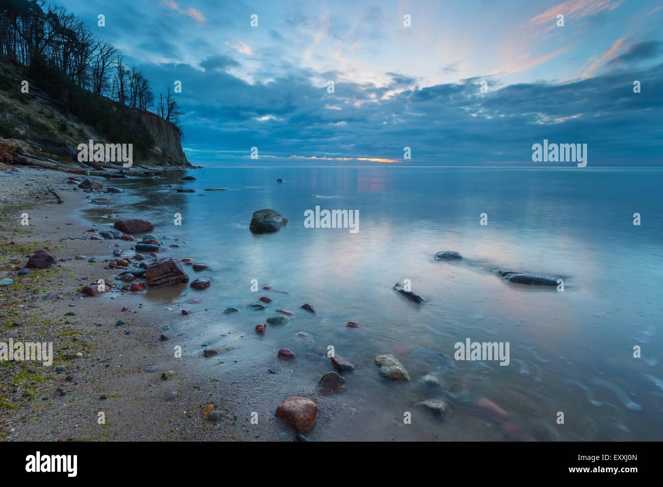 Beautiful rocky sea shore at sunrise or sunset. Long exposure landscape ...