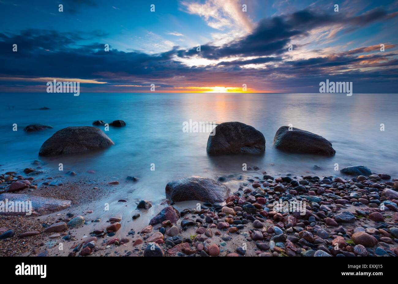 Beautiful rocky sea shore at sunrise or sunset. Long exposure landscape ...