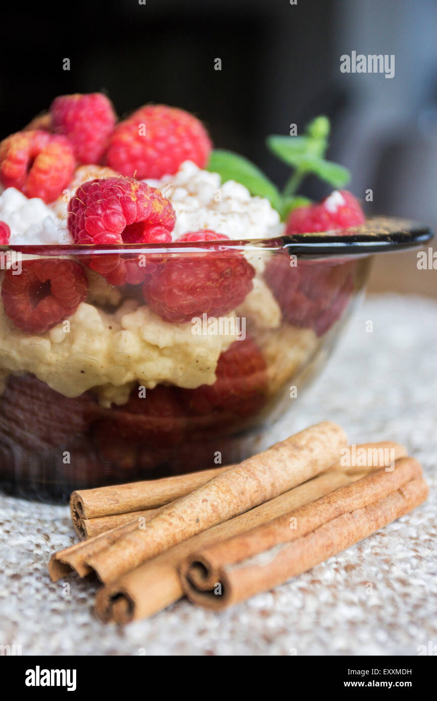 Rice pudding with raspberries and cinnamon Stock Photo - Alamy