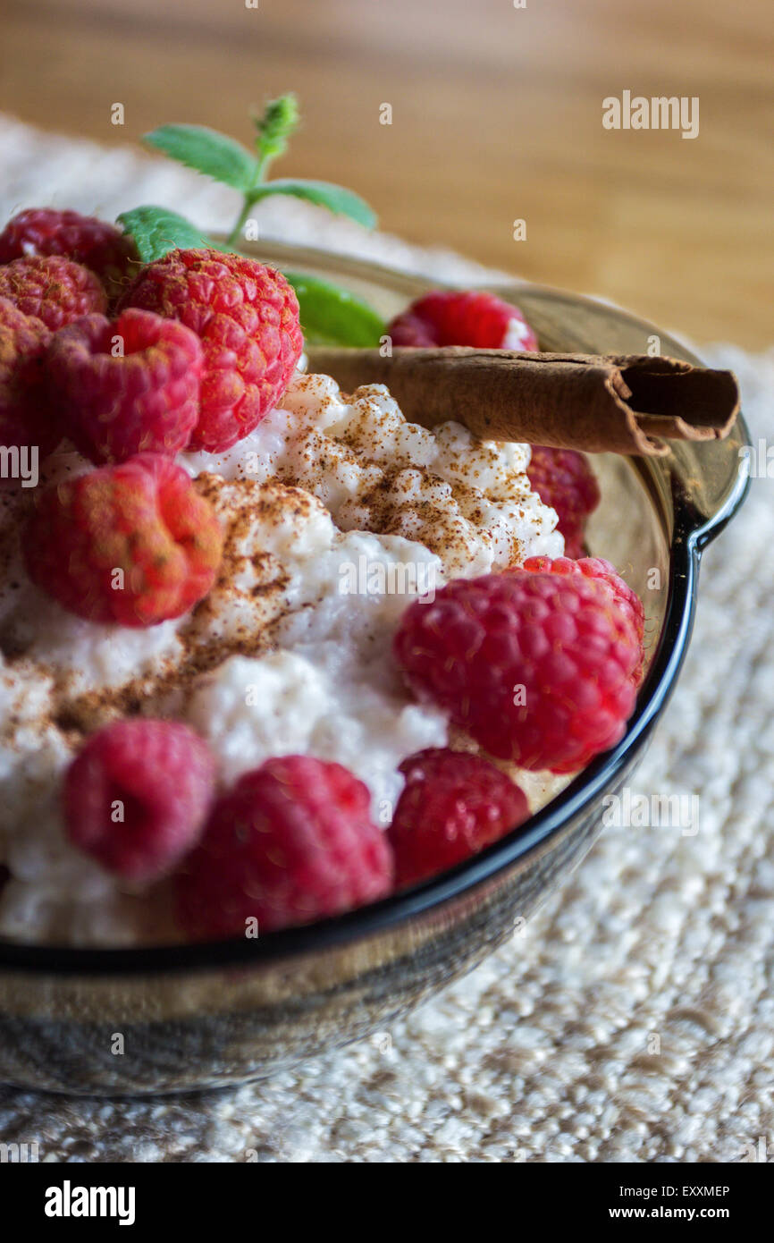Rice pudding with raspberries and cinnamon Stock Photo - Alamy
