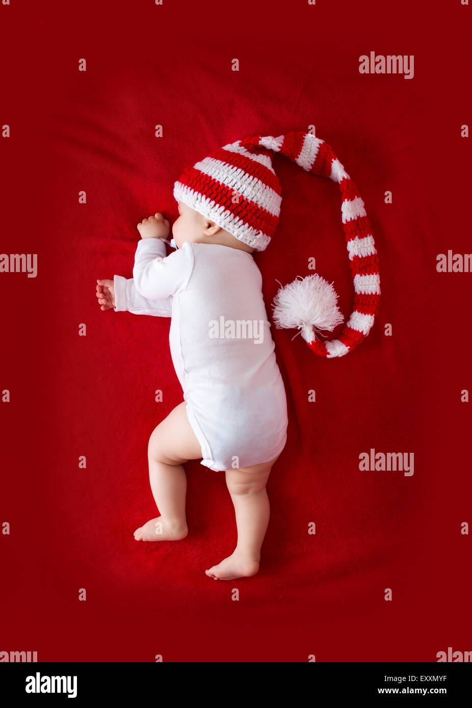 Baby in red white knitted hat Stock Photo