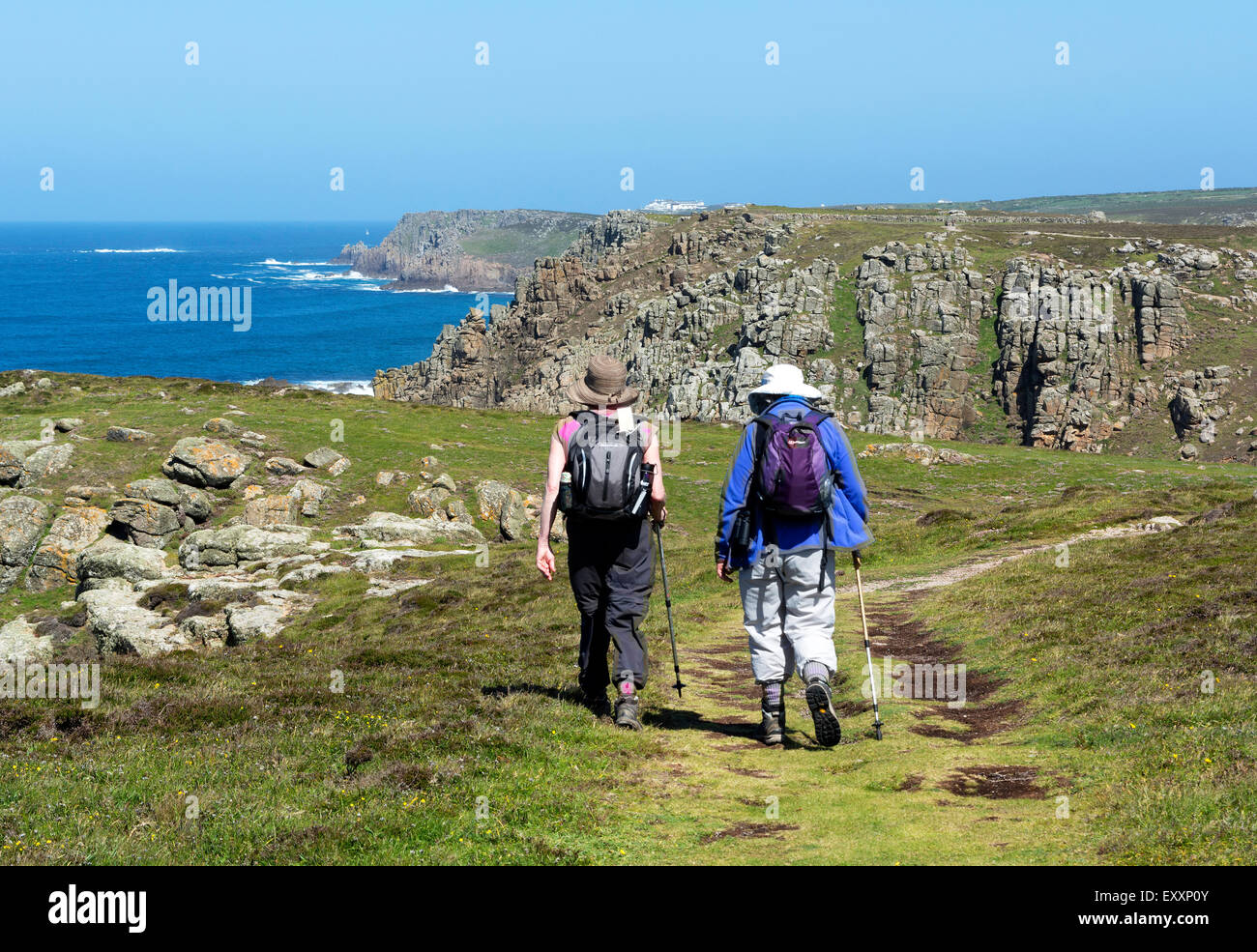 Walkers on the southwest coastal path at Gwennap Head near Lands End in Cornwall, England, UK Stock Photo