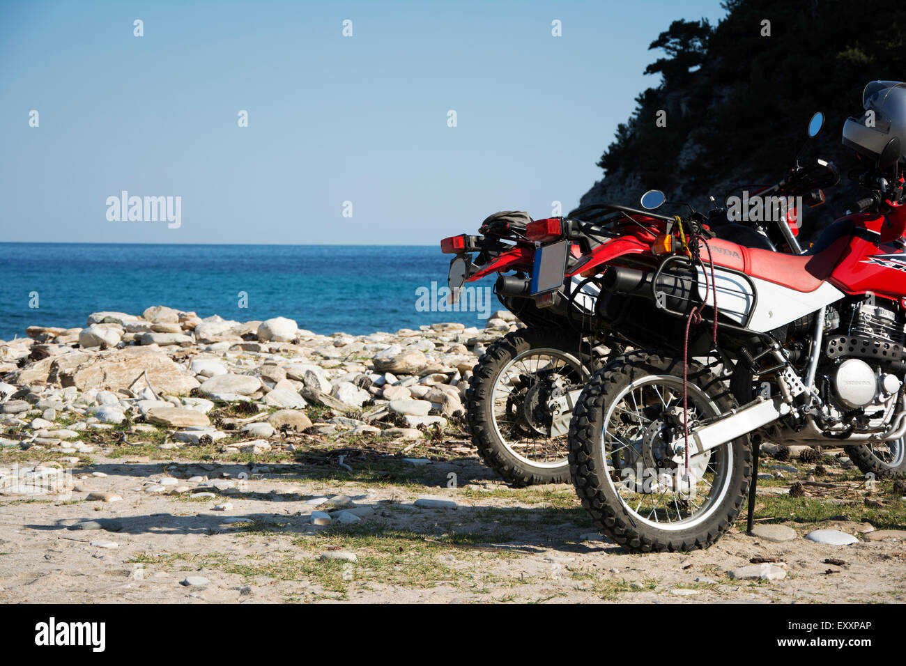 Thassos island, Greece, 23th of June 2015: Two motorbikes HONDA 650L XR parked on the Livadi beach in southern part of Thassos i Stock Photo