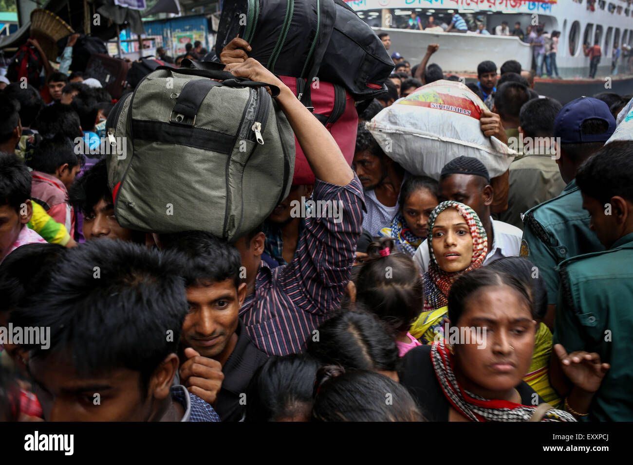 Dhaka, Bangladesh. 16th July, 2015. July 16, 2015 - Dhaka, Bangladesh - DHAKA - the capital city of Bangladesh with more than 150 million citizens which is considered as the most densely populated city on earth. Country's administrative system is so much centralized that people from each part the country come to this city for the sack of profession. Each year these huge numbers of people go back to their home to celebrate EID. Sadarghat Terminal is the vital riverine port of the capital city which connects southern parts of the country. Thousands of people gathered here to go home to celebr Stock Photo