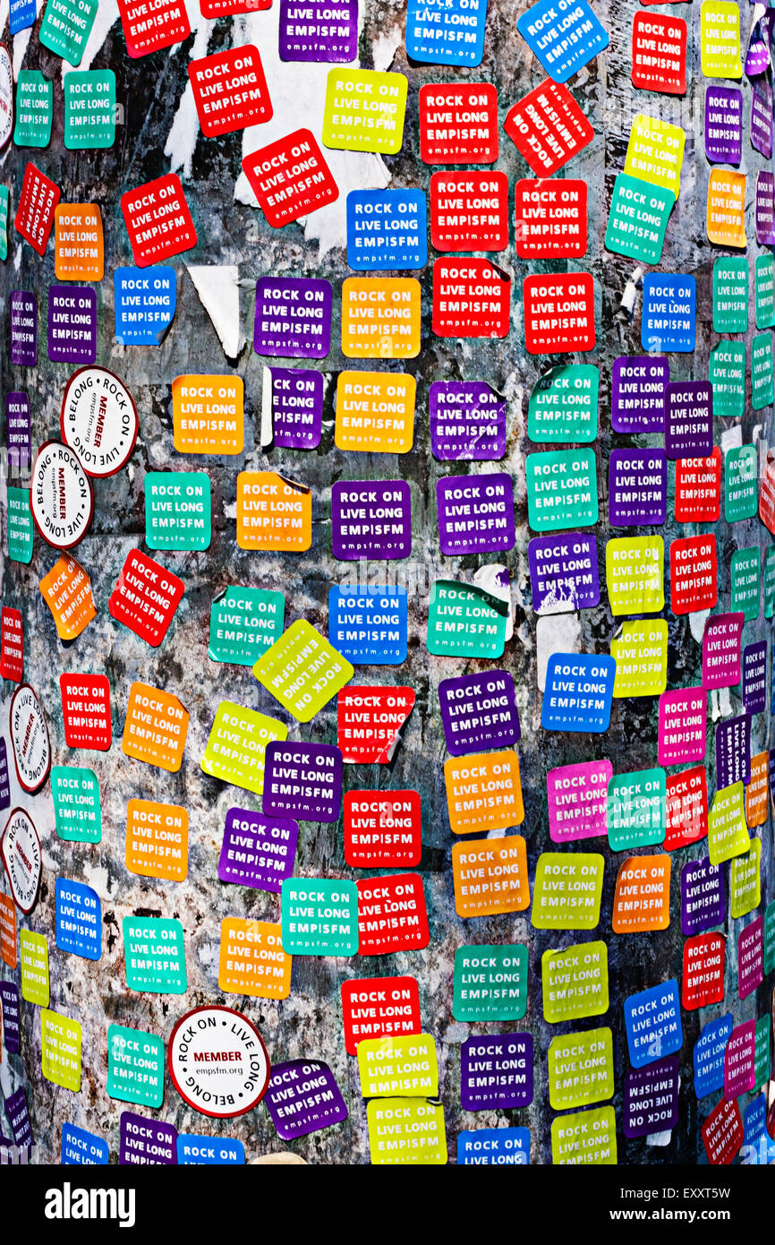 A lamp post decorated with day pass stickers for the Experience Music Project and Science Fiction Museum Stock Photo
