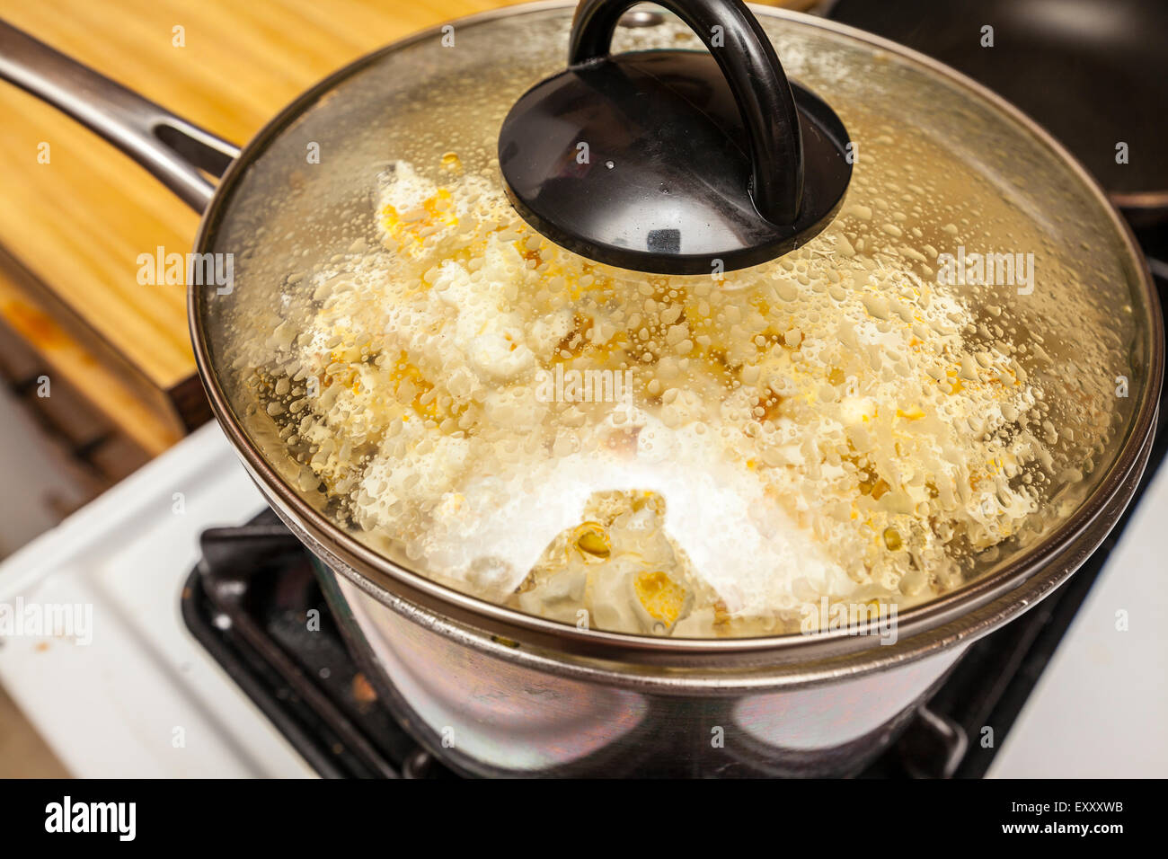 Popcorn popping in a pan on a stove Stock Photo Alamy