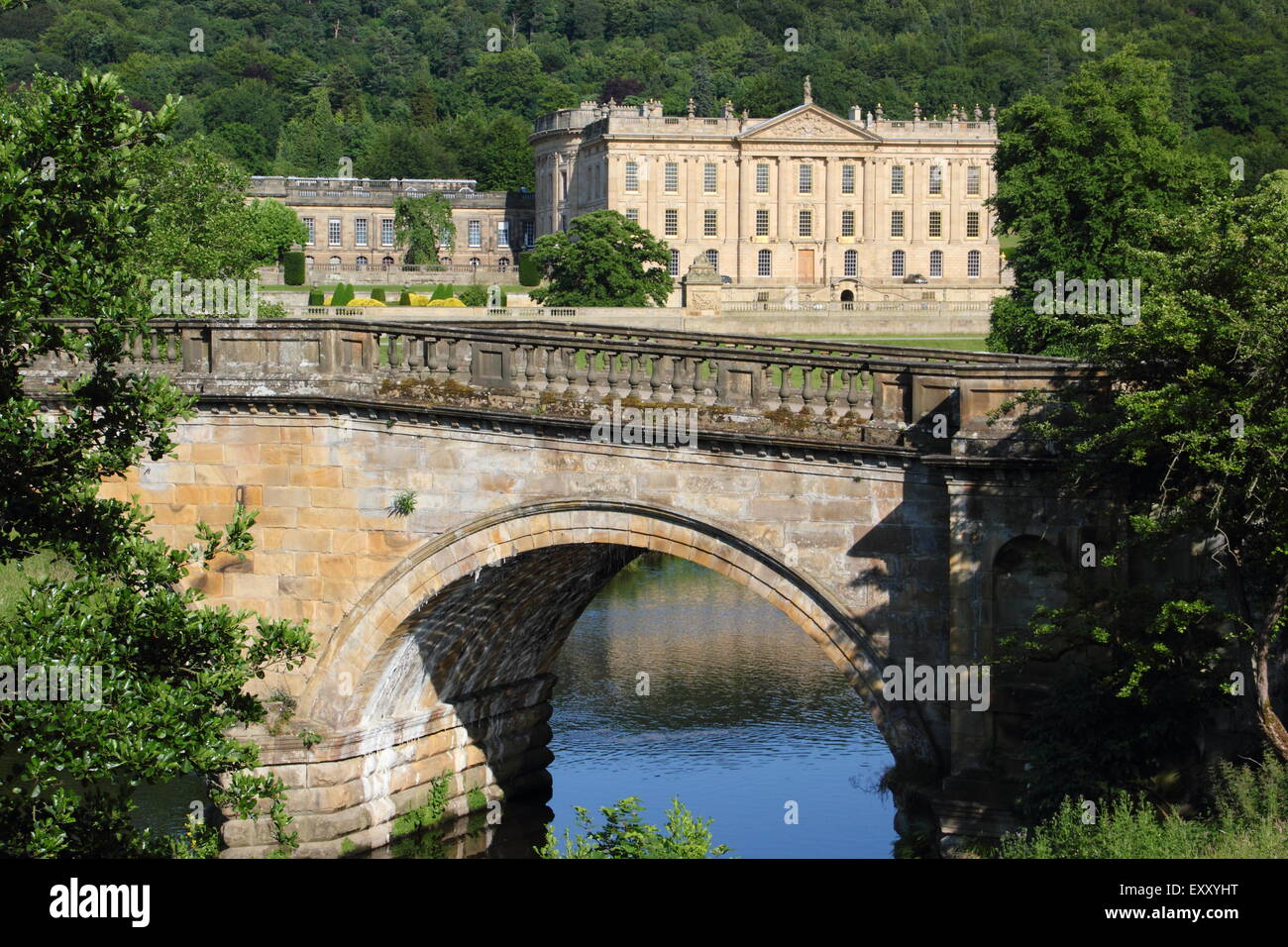 Chatsworh House from the arched bridge on the main approach to the Derbyshire stately home, Peak District,  England UK Stock Photo