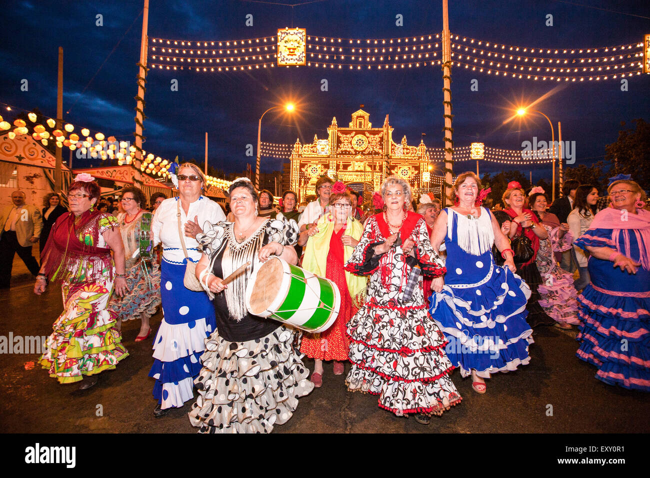 Dancing to drum beat and in traditional Seville dress in