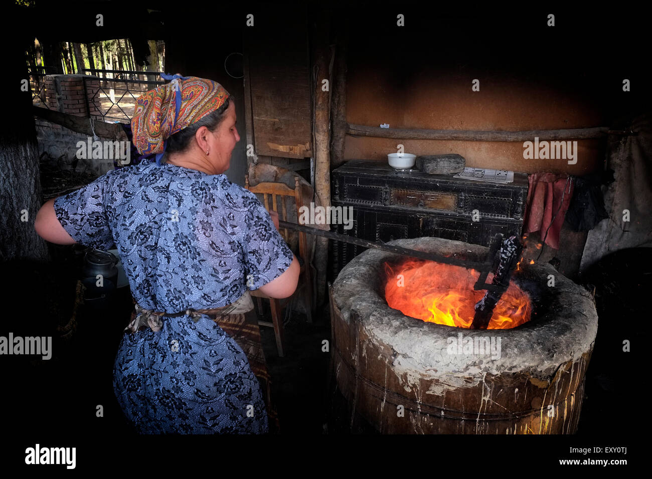 A Local Woman Baking Lavash Bread In A Deep Circular Clay Oven Called 