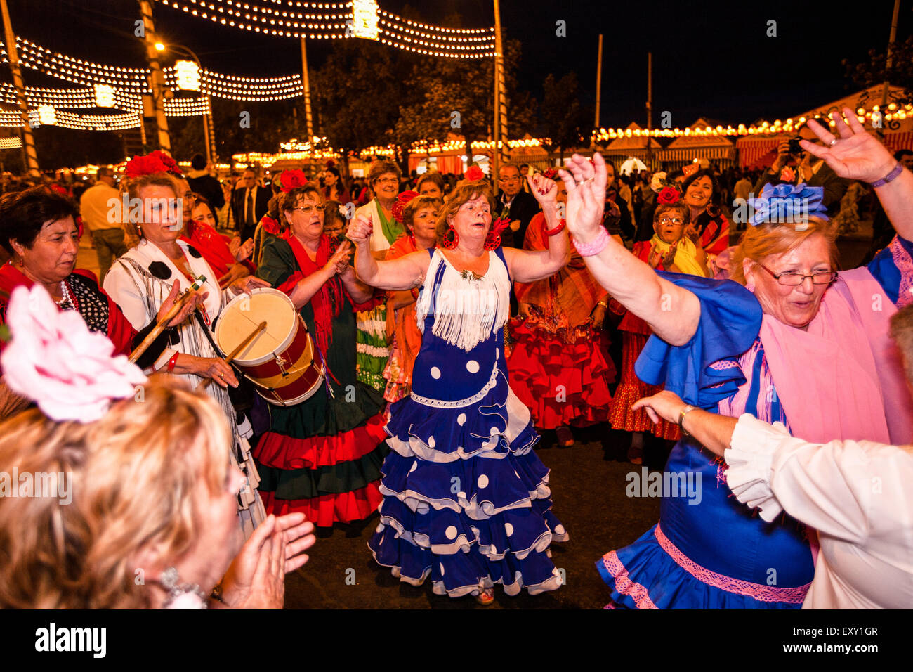 Dancing to drum beat and in traditional Seville dress in