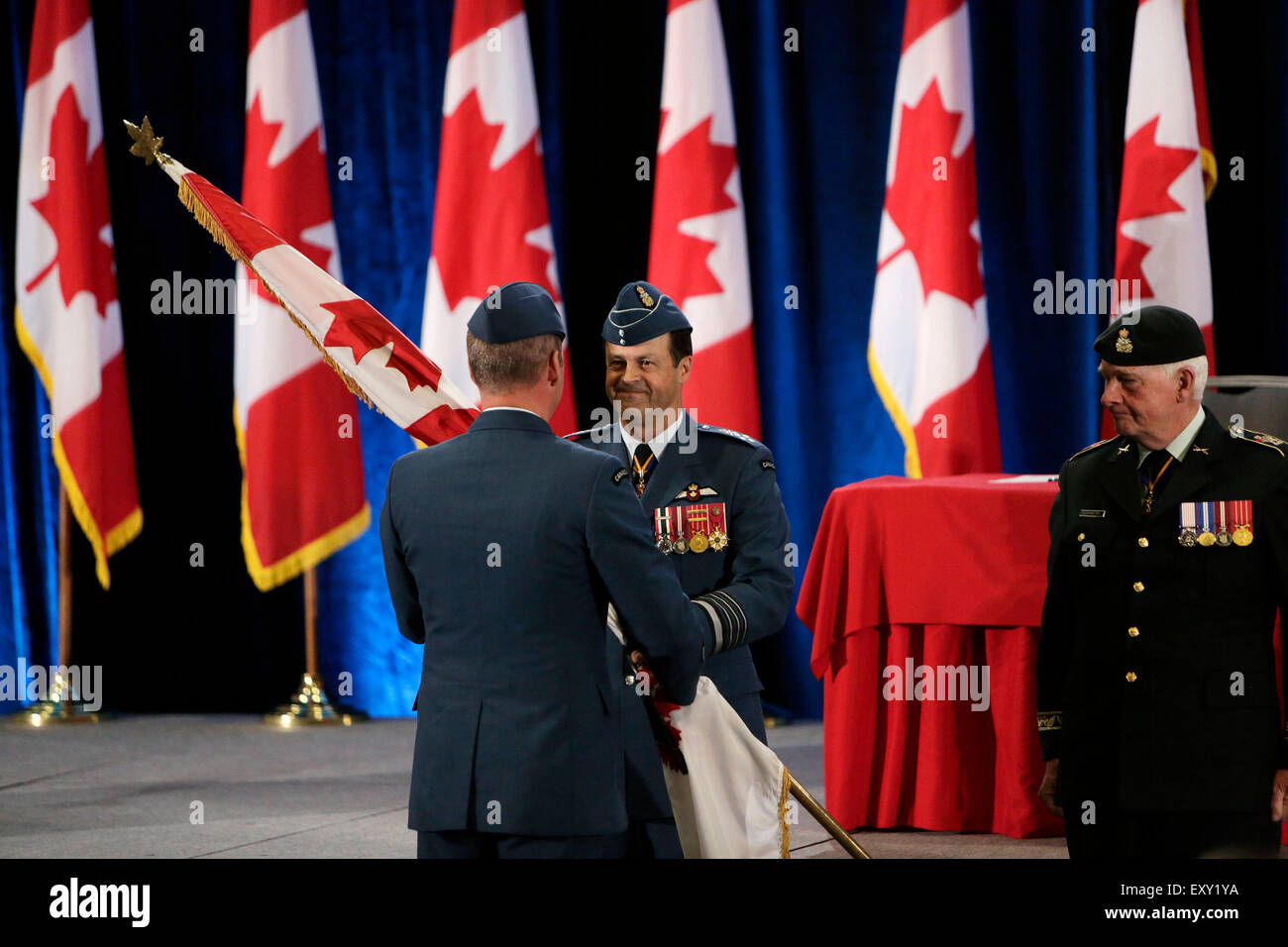 Ottawa, Canada. 17th July, 2015. Canadian outgoing Chief of Defence Staff General Tom Lawson hands over a pennant to the new Chief of Defence Staff General Jonathan Vance during a change of command ceremony at the Shaw Centre in Ottawa, Canada, on July 17, 2015. General Jonathan Vance officially replaced General Tom Lawson to be Canada's Chief of the Defense Staff (CDS) here on Friday morning. Credit:  David Kawai/Xinhua/Alamy Live News Stock Photo