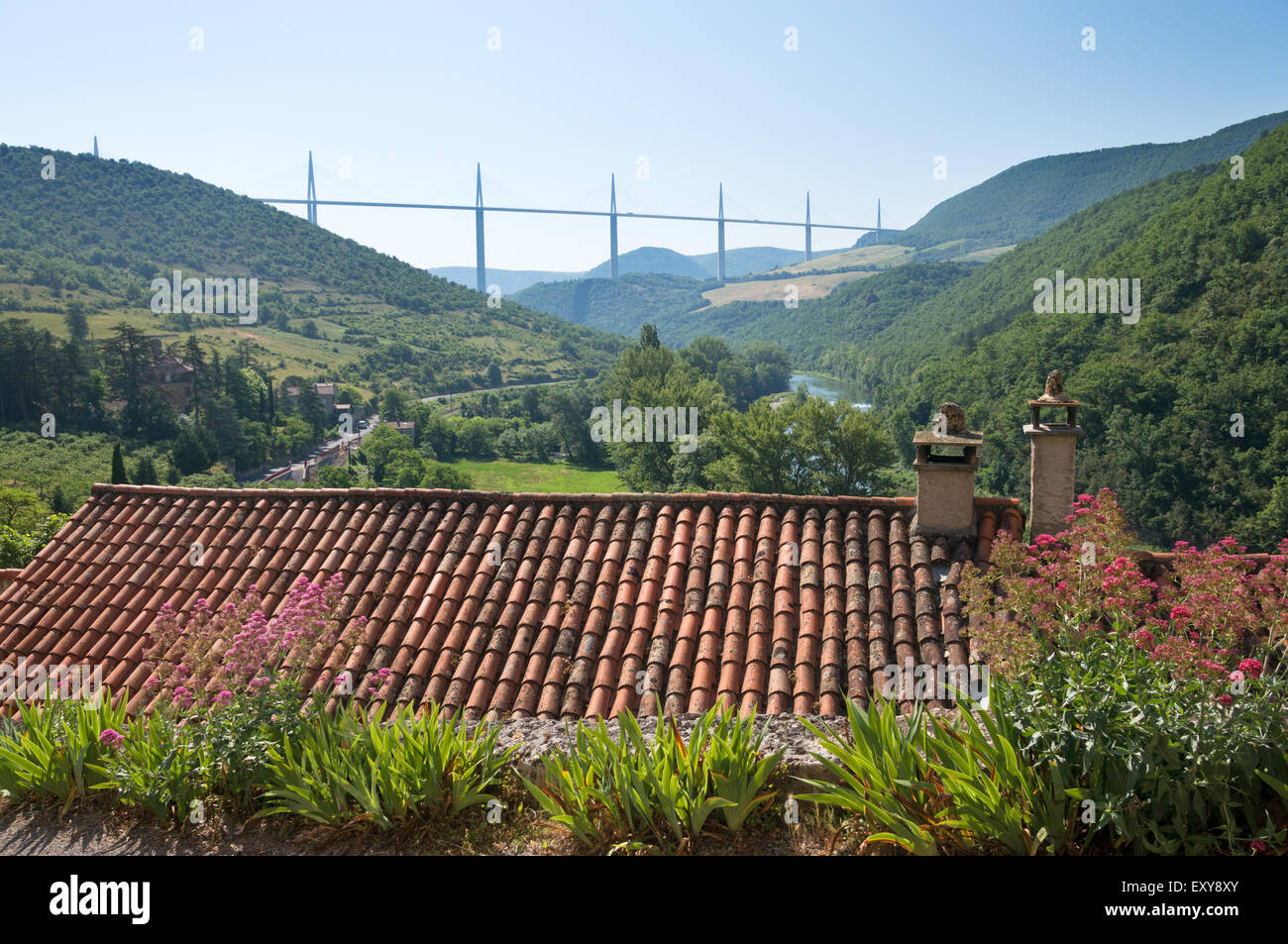 Millau viaduct and the river Tarn seen above pantiled roof from the village of Peyre, Aveyron,  Midi-Pyrénées, France , Europe Stock Photo