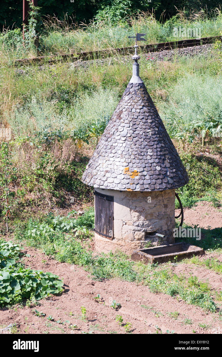 Old water pump in small building with conical roof, Peyre village, Aveyron,  Midi-Pyrénées, France , Europe Stock Photo