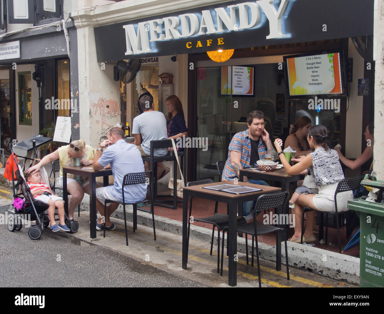 People enjoy drinks and food in a cafe in the Arab St. quarter in