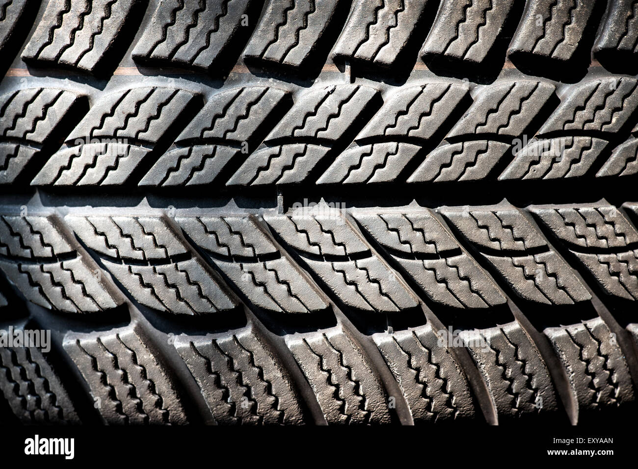 Detail of a winter tire tread on a new motor vehicle tire designed to operate at lower temperature and give additional grip and Stock Photo