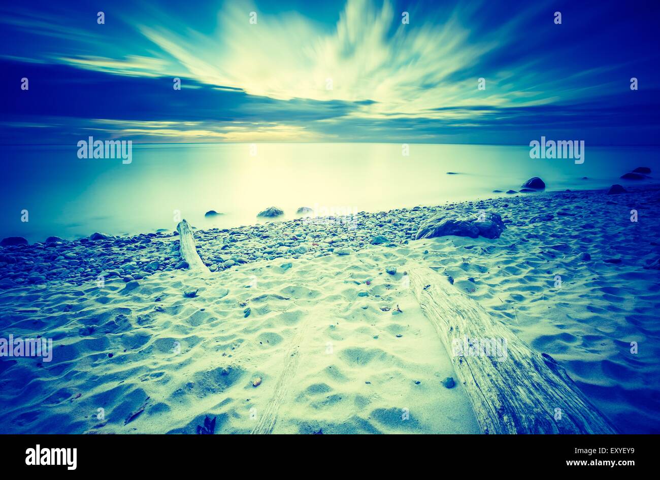 Vintage photo of beautiful rocky sea shore at sunrise or sunset. Long ...