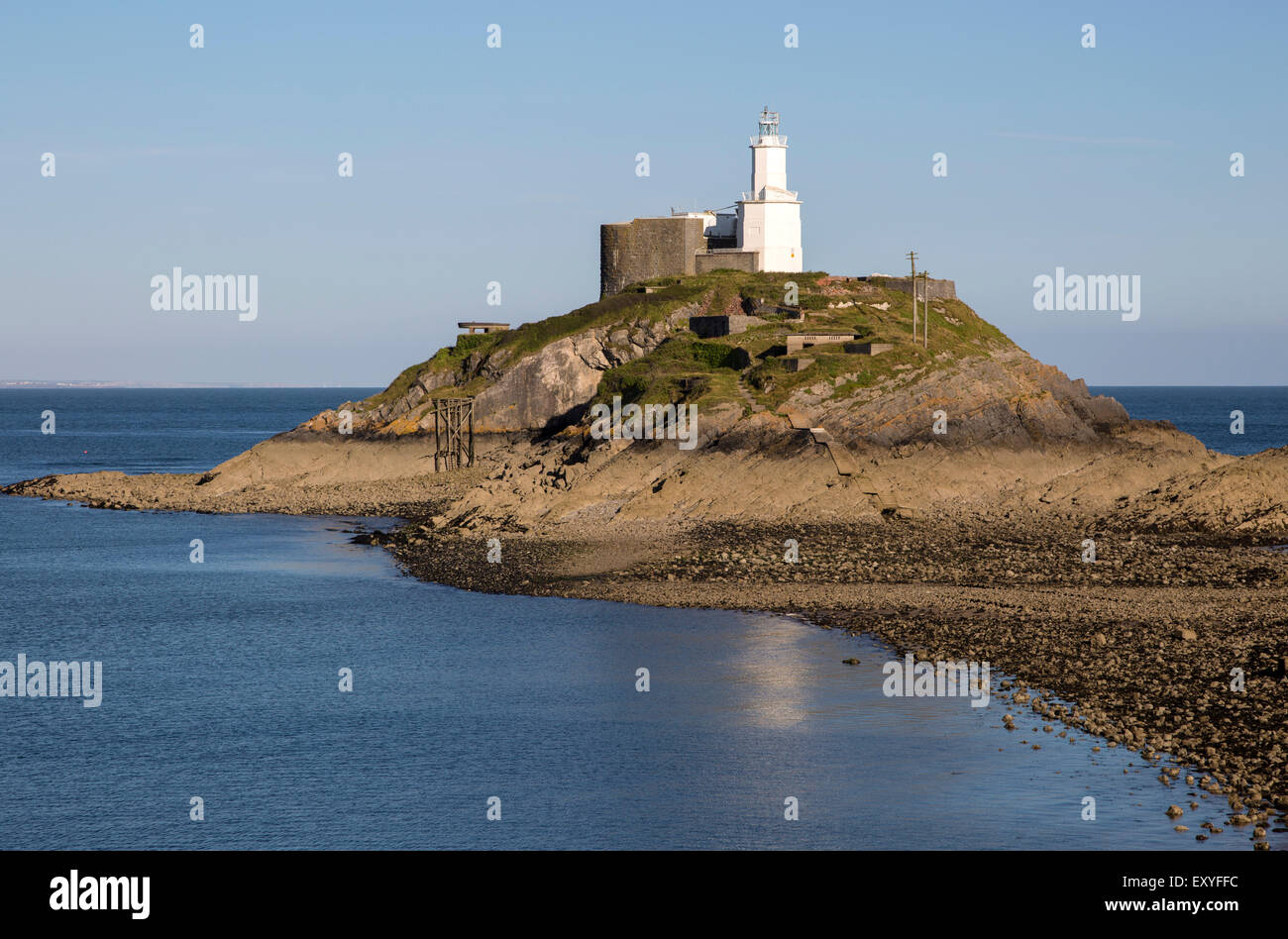 Lighthouse at low tide Mumbles Head, Gower peninsula, near Swansea, South Wales, UK Stock Photo