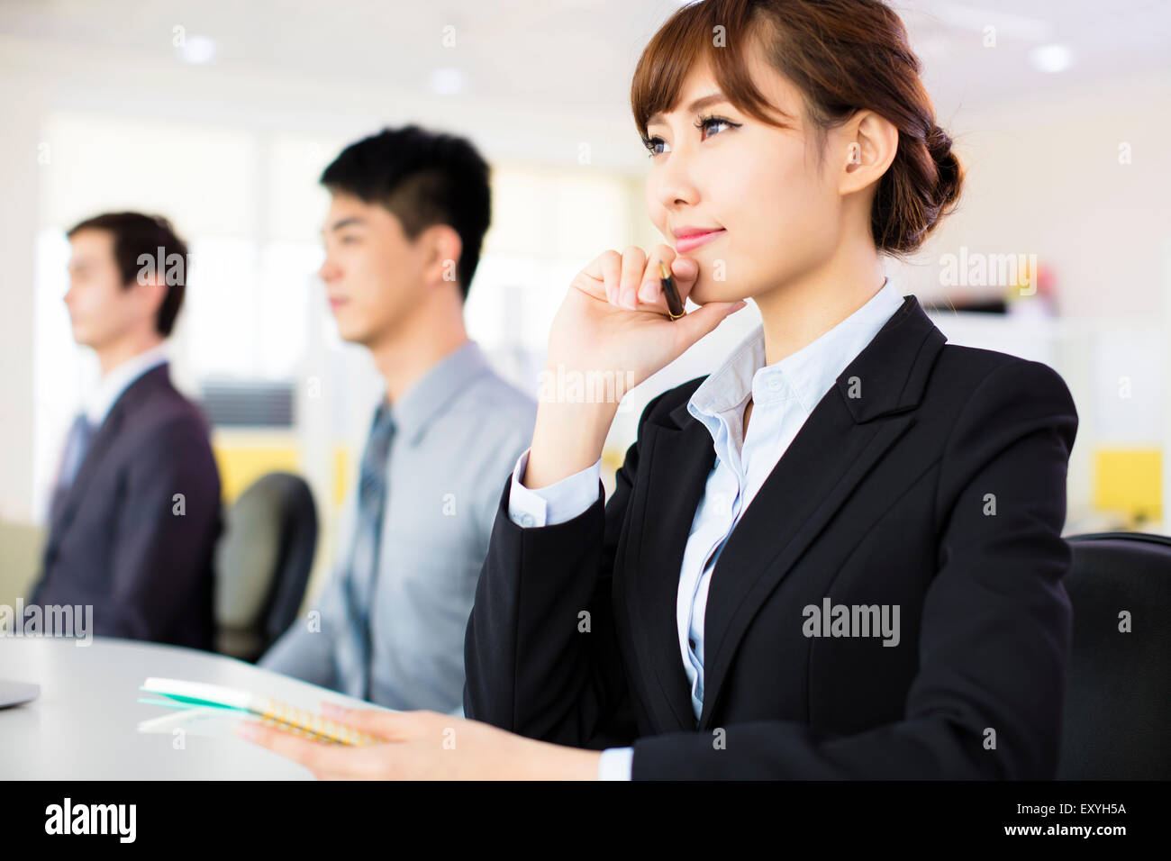 Business people sitting in a row and meeting Stock Photo - Alamy
