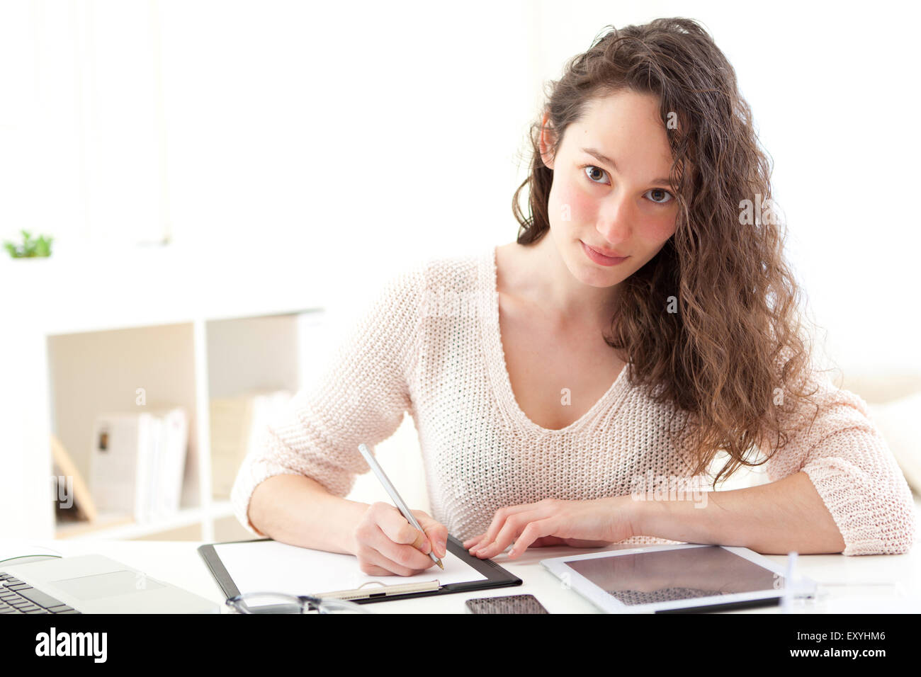 View of a Young attractive business woman copying data on paper Stock Photo