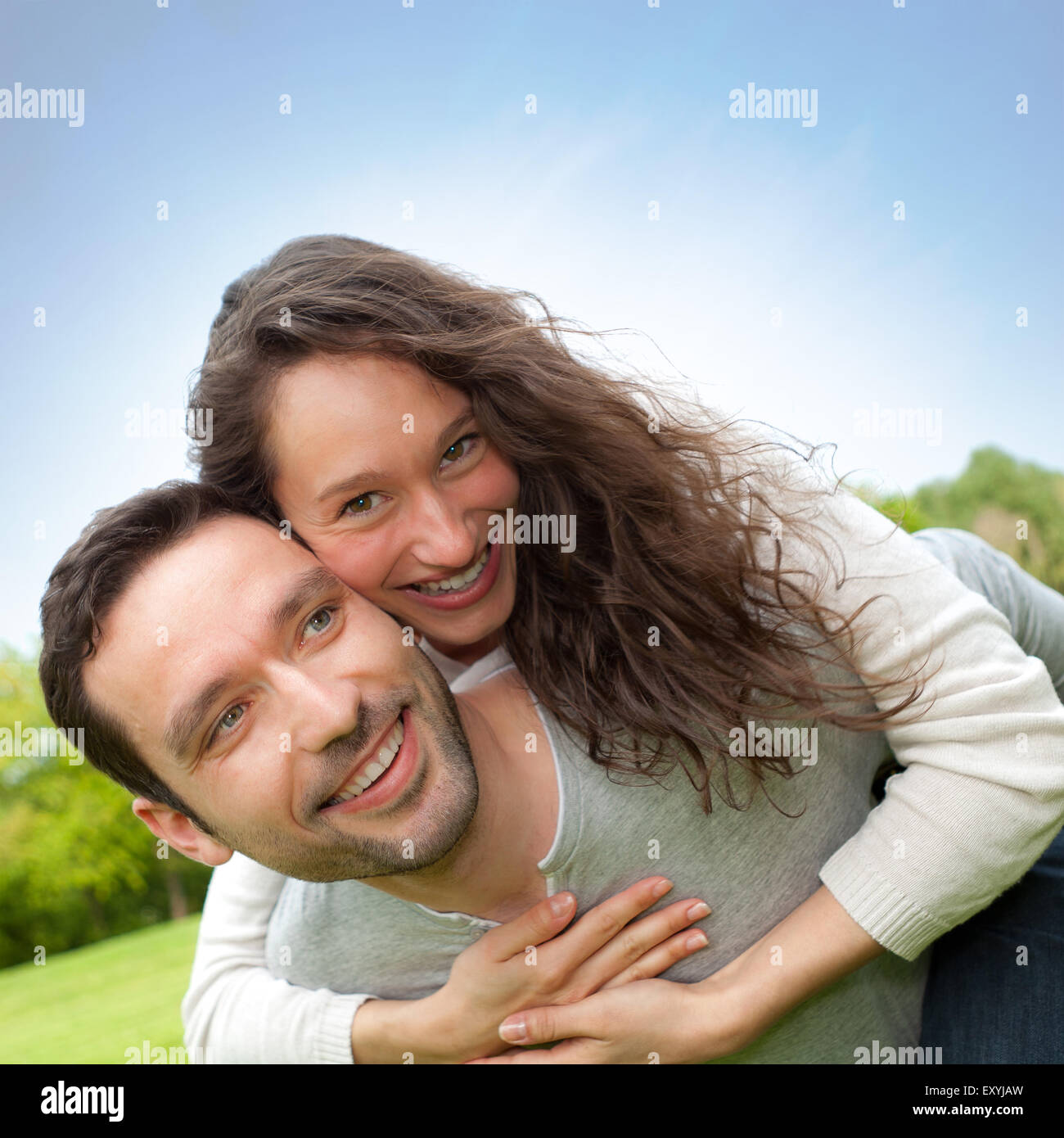 View of a Young happy couple having fun at the park Stock Photo - Alamy