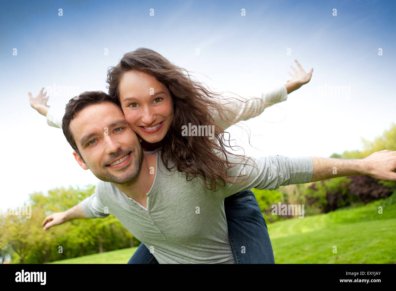 View of a Young happy couple having fun at the park Stock Photo - Alamy