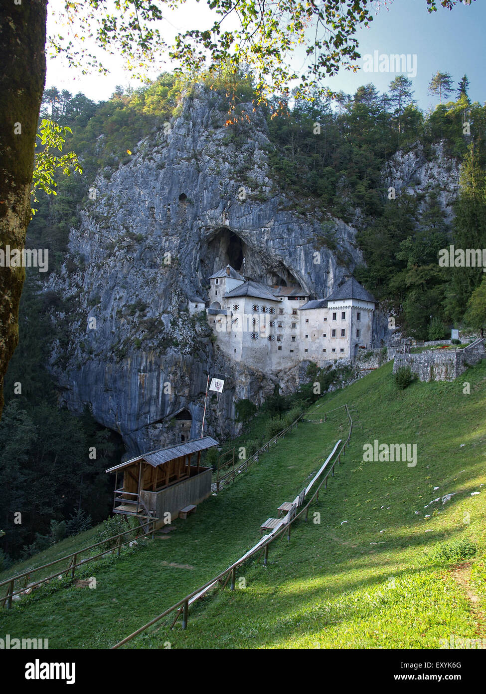 View of Predjama castle, a renaissance castle built in a cave, with a field for medieval tournaments, near Postojna. Slovenia. Stock Photo