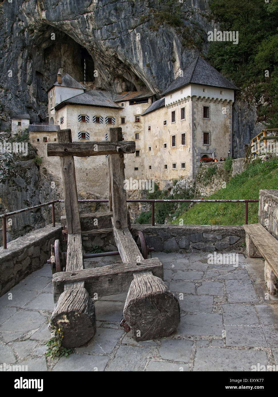 Wood catapult with Predjama castle, a renaissance castle built in a cave, at the background, near Postojna. Slovenia. Stock Photo