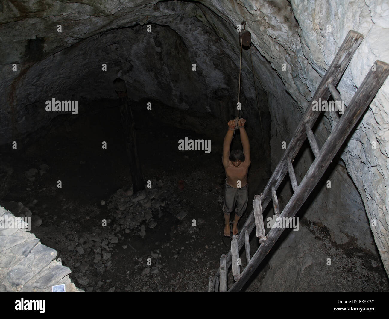 A dummy of a man hanging by his arms in the dungeons at Predjama castle, near Postojna. Slovenia. Stock Photo