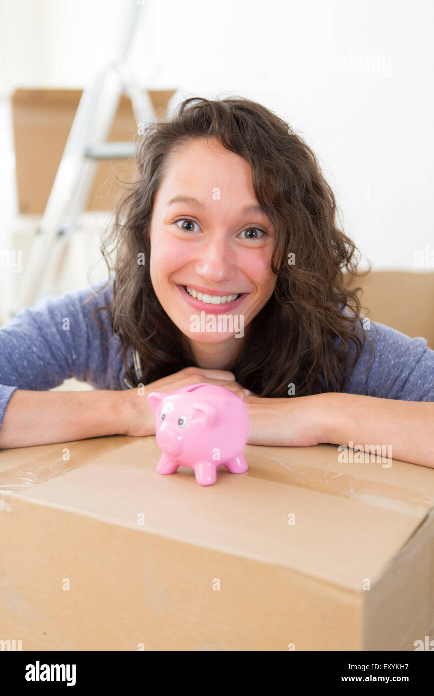 View of a Young couple saving money in a piggy bank Stock Photo - Alamy