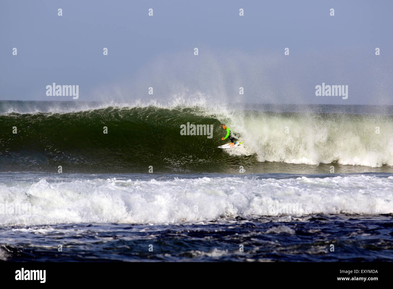 Australian surfer Julian Wilson in the barrel while surfing a wave at Jeffreys Bay, South Africa Stock Photo