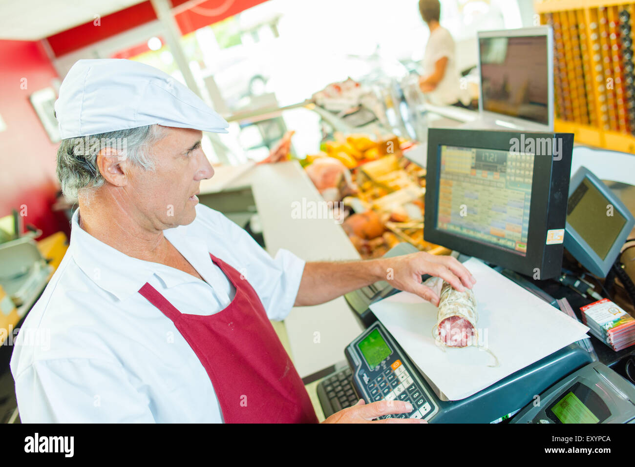 Butcher weighing cured meat Stock Photo Alamy