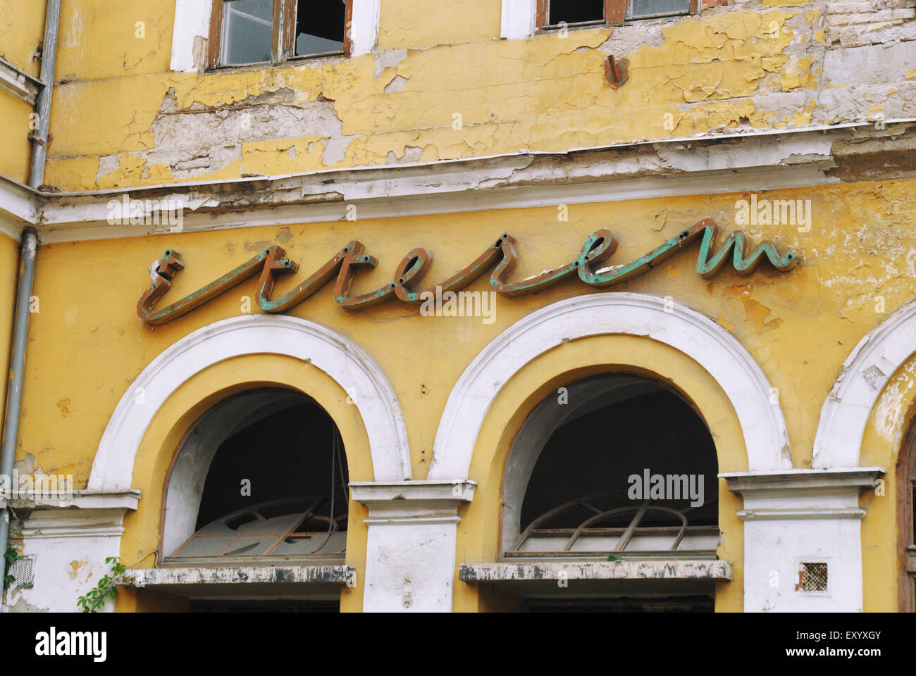 An old communist-era neon 'Étterem' (Restaurant) sign on the façade of a ruined building. Stock Photo