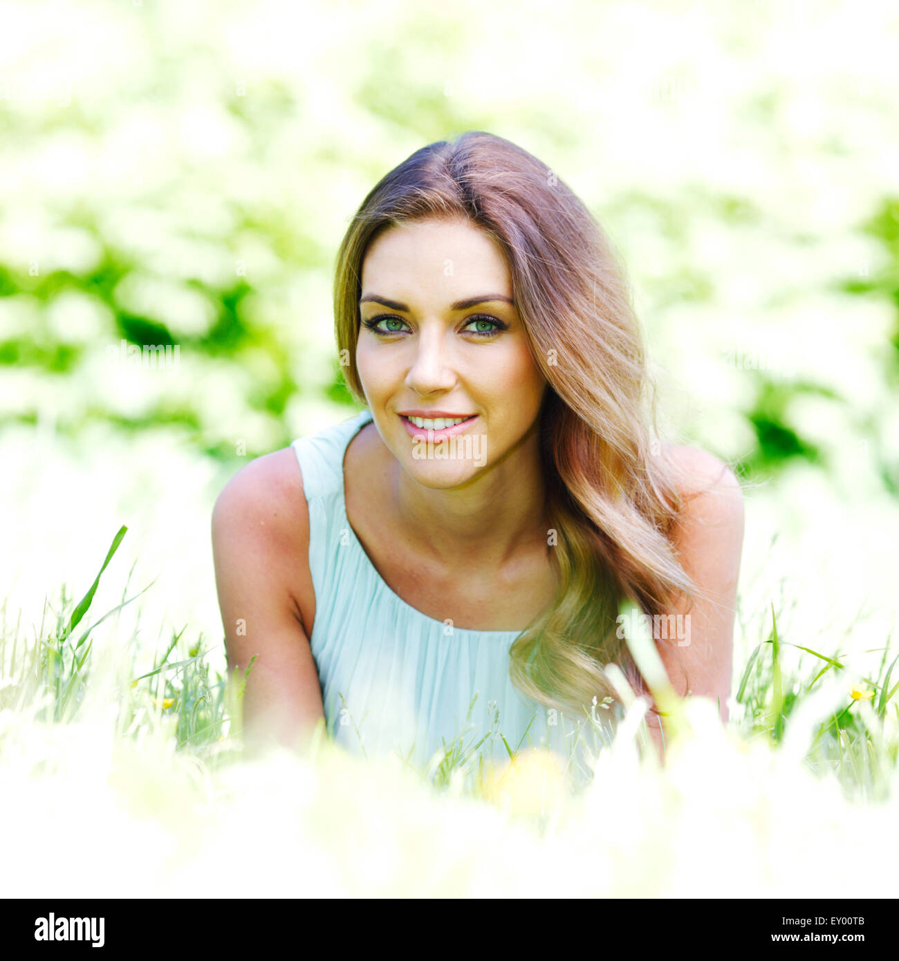 young woman in blue dress lying on grass Stock Photo - Alamy