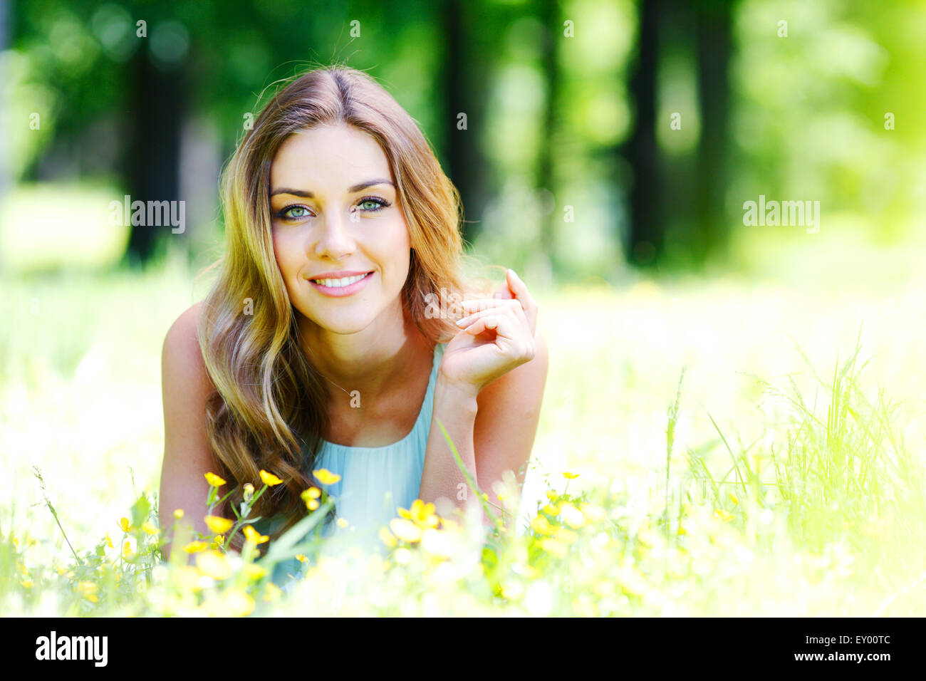 young woman in blue dress lying on grass Stock Photo - Alamy