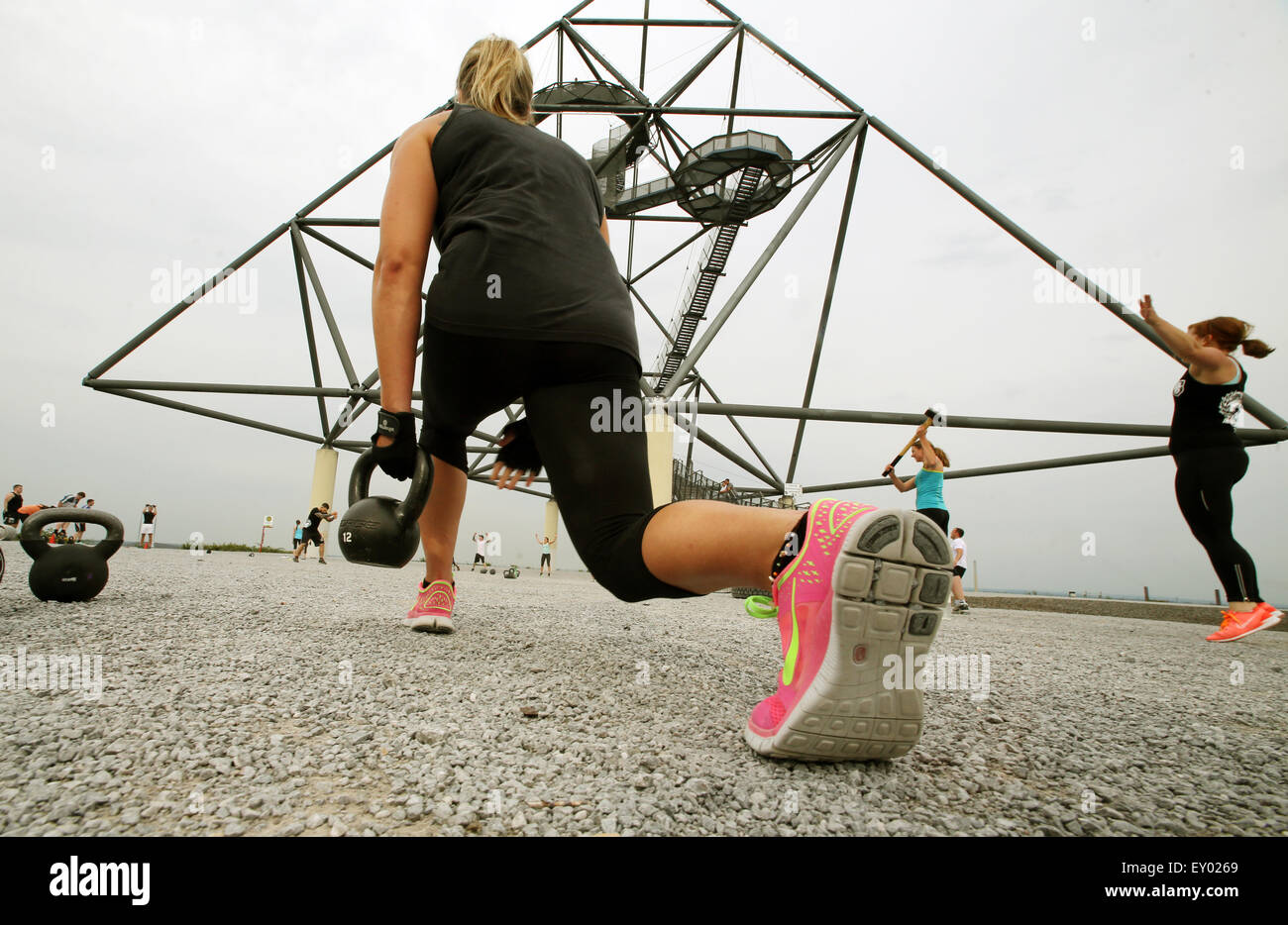 Members of the 'Hartmetall Ruhrpott' fitness club training in Bottrop, Germany. 26 June 2015. In this special fprm of fitness training, truck tires are bit with hammers, sandbags swung and barrels hiosted aloft. Photo: Roland Weihrauch/dpa Stock Photo