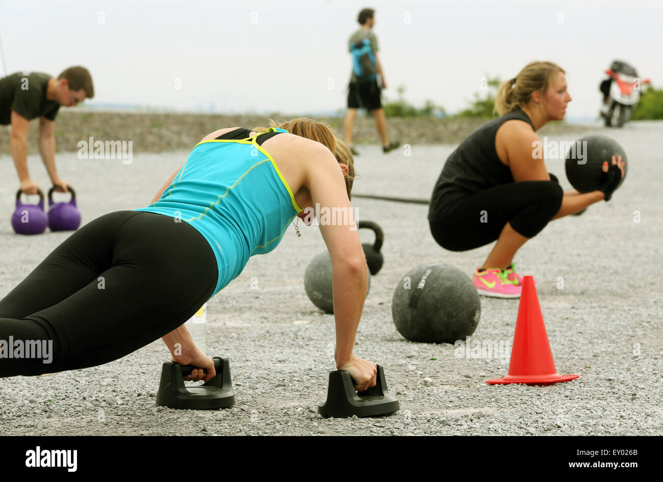 Members of the 'Hartmetall Ruhrpott' fitness club training in Bottrop, Germany. 26 June 2015. In this special fprm of fitness training, truck tires are bit with hammers, sandbags swung and barrels hiosted aloft. Photo: Roland Weihrauch/dpa Stock Photo