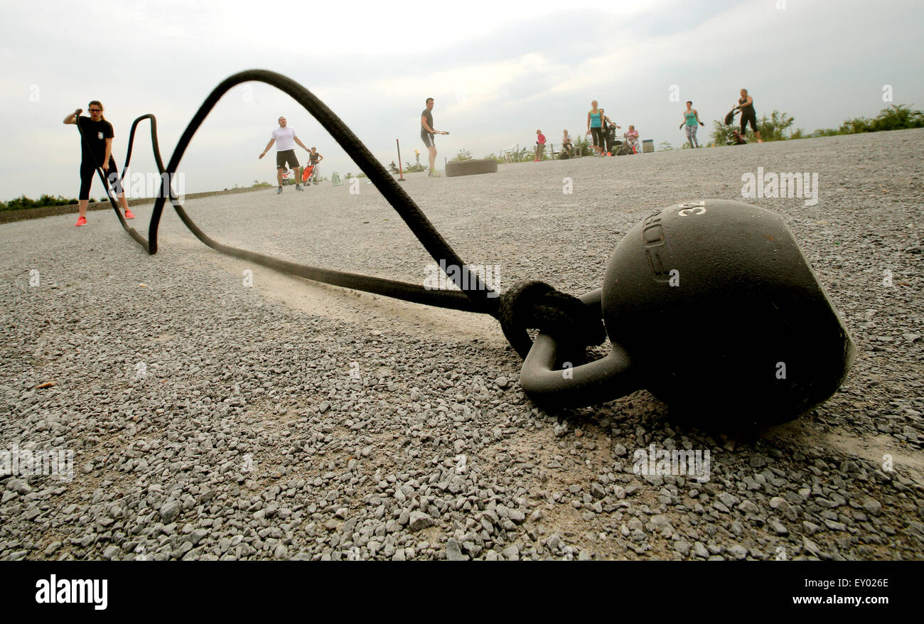 Members of the 'Hartmetall Ruhrpott' fitness club training in Bottrop, Germany. 26 June 2015. In this special fprm of fitness training, truck tires are bit with hammers, sandbags swung and barrels hiosted aloft. Photo: Roland Weihrauch/dpa Stock Photo