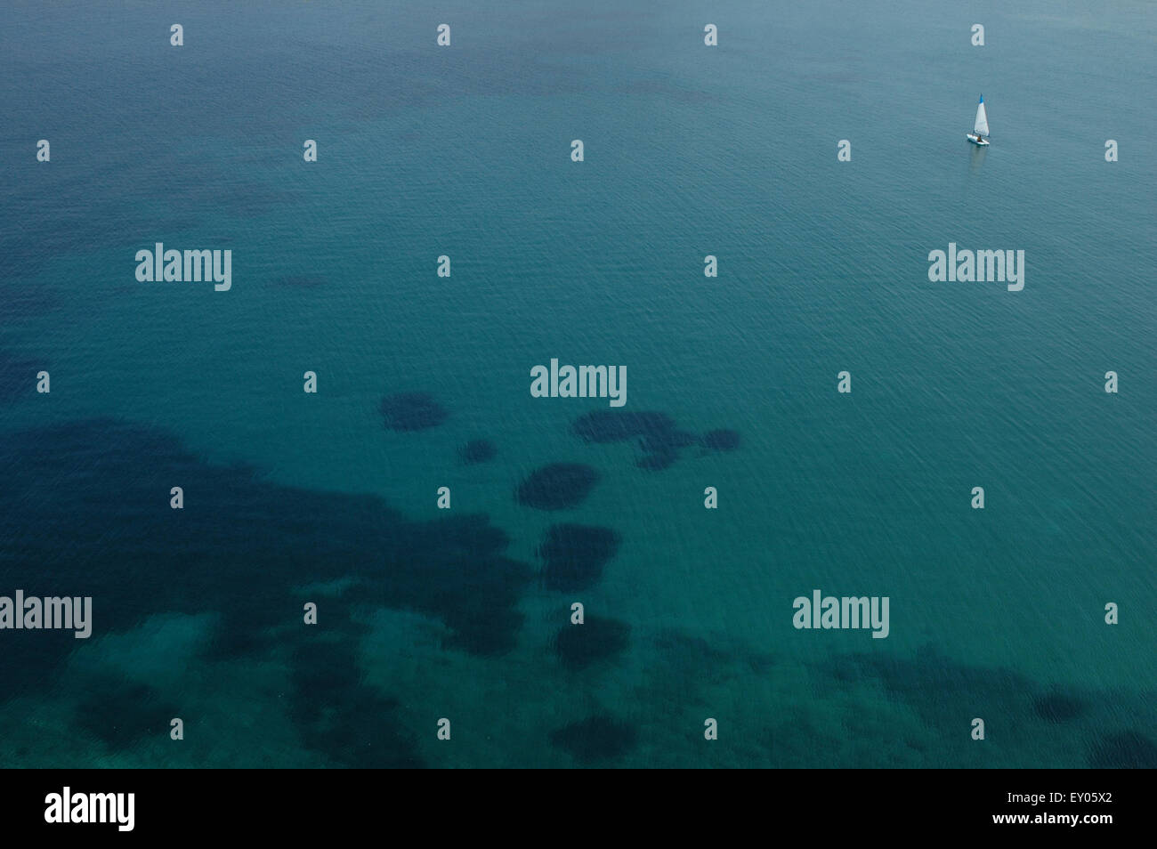 Laser sailing boat floats on the sea surface. Romeikos bay, Limnos or