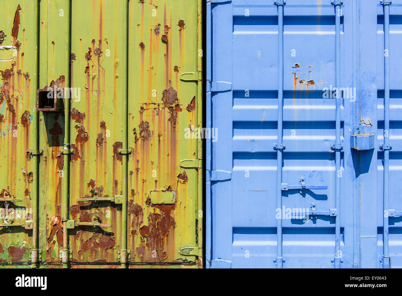 Disused and rusting shipping containers of contrasting colors. Stock Photo