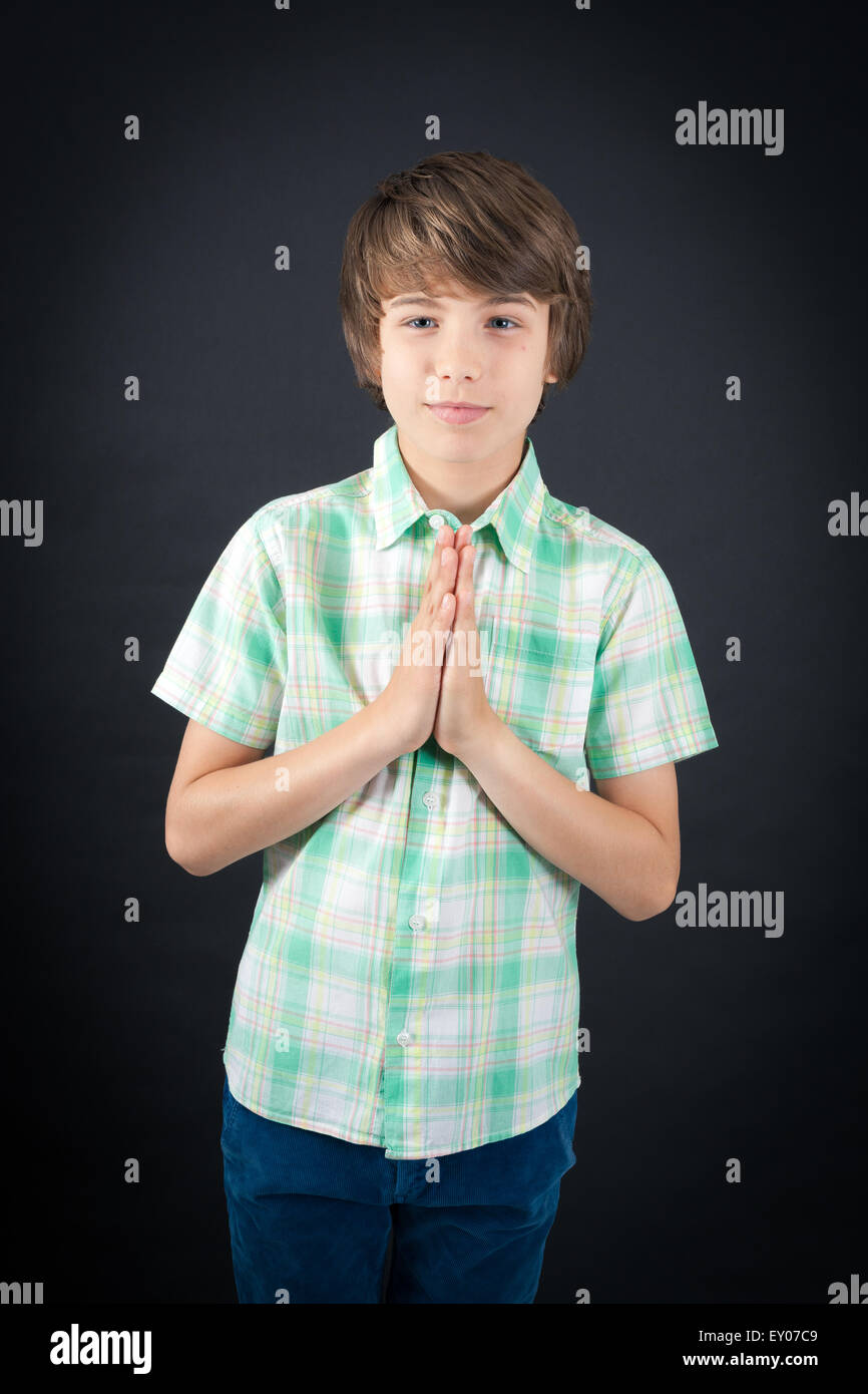 Handsome boy doing different expressions in different sets of clothes: prayer Stock Photo